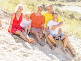 Happy family sitting in the dunes - LAF01765