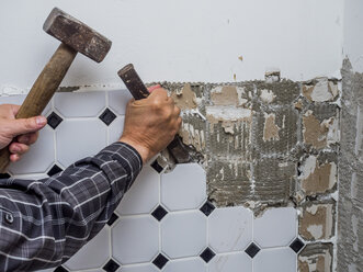 Tiles being removed from wall during a refurbishment - EJWF00796