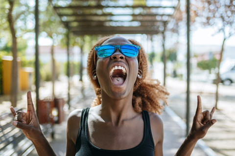 Young woman screaming outdoors stock photo
