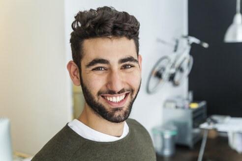 Portrait of content man in a modern office - TCF05128