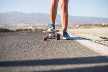 Spain, Tenerife, female skater standing on skateboard, blue shoes - SIPF00908