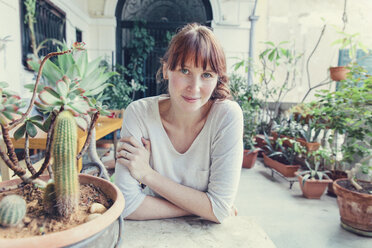 Woman sitting at table on mediterranean terrace - MFF03380