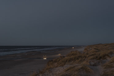 Dänemark, Blokhus, Autos am Strand in der Abenddämmerung - MJF02007