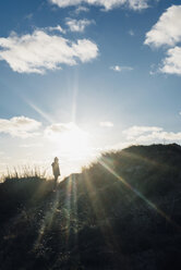 Denmark, North Jutland, boy in dunes in backlight - MJF02051