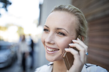 Smiling woman talking on cell phone - ZEF10486