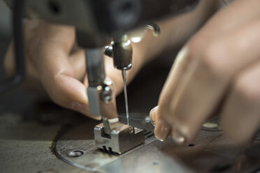 Seamstress working at sewing machine, close up - ZEF10543