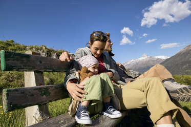 Family on a hiking trip resting on a bench - FSF00561