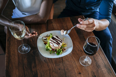 Close-up of a couple eating together in restaurant - KIJF00835