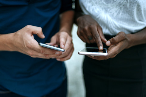 Close-up of couple using smartphone stock photo