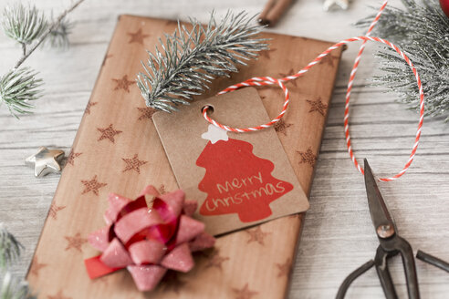 Christmas decoration, scissors and wrapped presents on wood - SARF02952