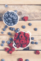Bowls of raspberries and blueberries on wood - RTBF00415