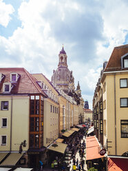 Germany, Dresden, view to dome of Dresden Frauenkirche with facades and shopping street in the foreground - KRP01851