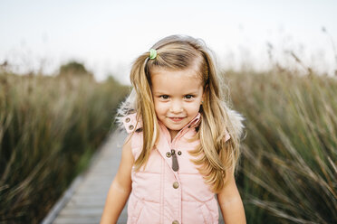 Portrait of smiling little girl in nature - JRFF00875