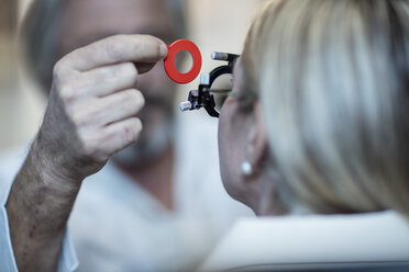 Optometrist adjusting test frame for patient - ZEF10568