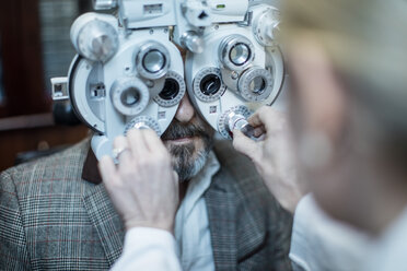 Female optometrist doing eye test with patient - ZEF10573