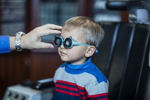 Boy doing eye test at optometrist stock photo