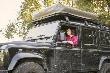 Senior woman on a trip in a cross country vehicle - ONF01018