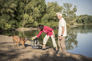 Senior couple with dog at a lake - ONF01025