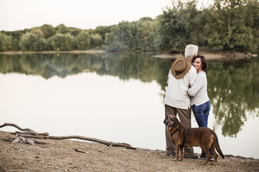 Senior couple with dog at a lake - ONF01050