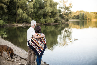 Senior couple with dog at a lake - ONF01096