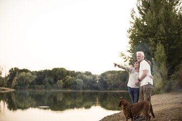 Senior couple with dog at a lake - ONF01110