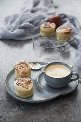 Filo pastry apple cakes in rose shape with cup of coffee - SARF02973