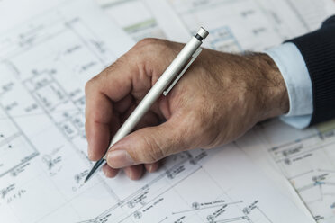 Hand of architect writing on ground plan - TCF05154