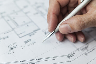 Hand des Architekten schreibt auf Grundriss - TCF05155