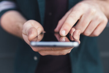 Index finger of young man touching smartphone - BOYF00623