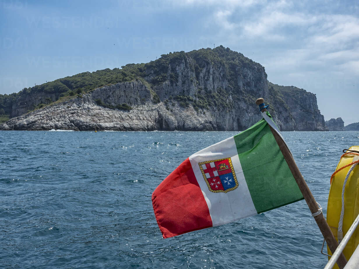 Italy, Liguria, Italian flag in front of Palmaria Island stock photo