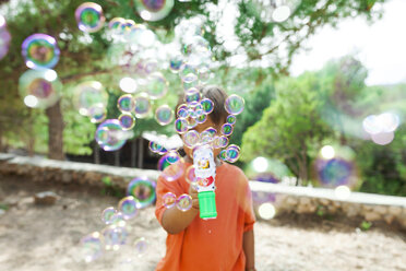 Little boy playing with soap bubble machine - VABF00804