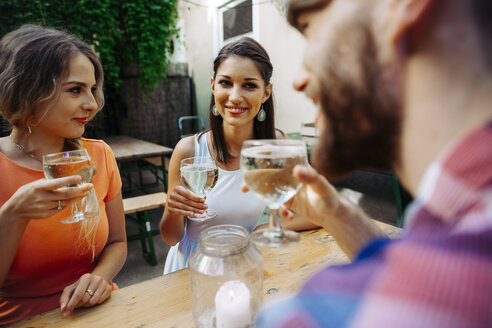 Friends drinking spritzer at outdoor pub - AIF00396