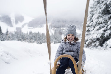 Happy girl on sledge in winter landscape - HAPF00948