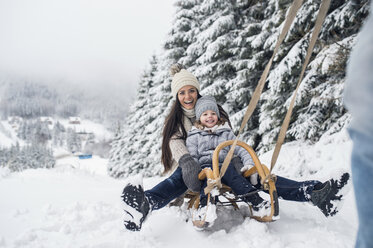 Happy family with sledge in winter landscape - HAPF00951