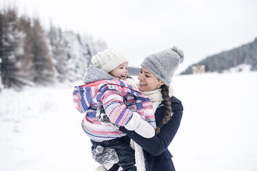 Happy mother carrying daughter in winter landscape - HAPF00988