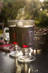 Two glasses of steaming mulled wine - SARF02983