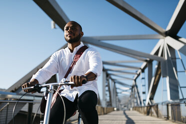 Man riding bicycle on a bridge - JRFF00916