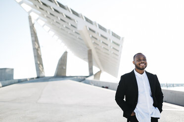 Smiling businessman at solar panels - JRFF00934