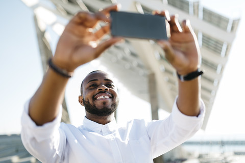 Mann nimmt Selfie im Freien, lizenzfreies Stockfoto