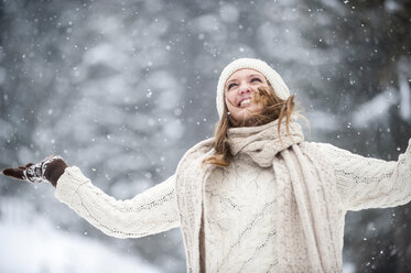 Young woman having fun in snow - HHF05419