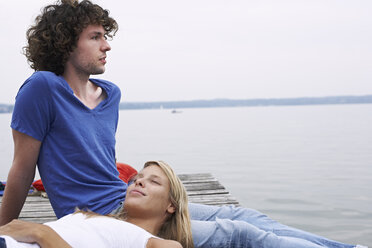 Young couple resting at a lake - FSF00575