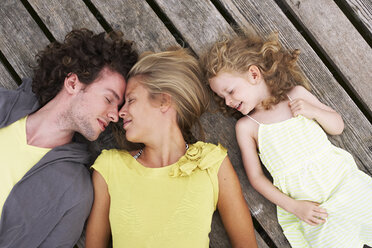 Relaxed family lying on a jetty - FSF00590