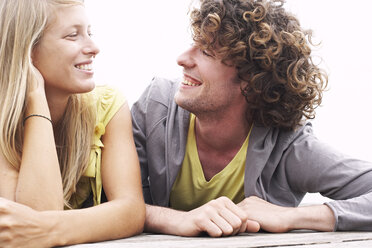 Smiling young couple lying on a jetty - FSF00597