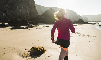 France, Crozon peninsula, teenage girl running on the beach - UUF08617