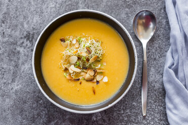 Bowl of sweet potato coconut soup with ginger, parsnip, leek, sprout and almond - SARF02994