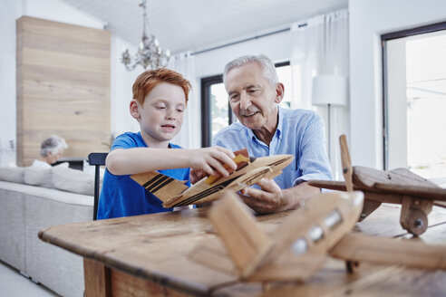 Grandfather and grandson building up model airplanes - RORF00329