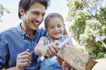 Father and daughter carving together - RORF00346