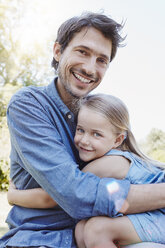 Father and daughter hugging outdoors - RORF00348