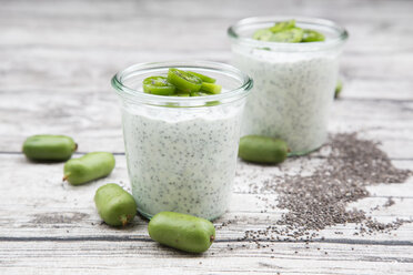 Two glasses of natural yoghurt with chia seeds and slices of hardy kiwis - LVF05461