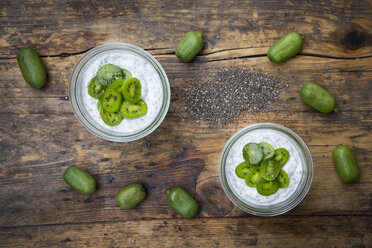 Two glasses of natural yoghurt with chia seeds and slices of hardy kiwis - LVF05463